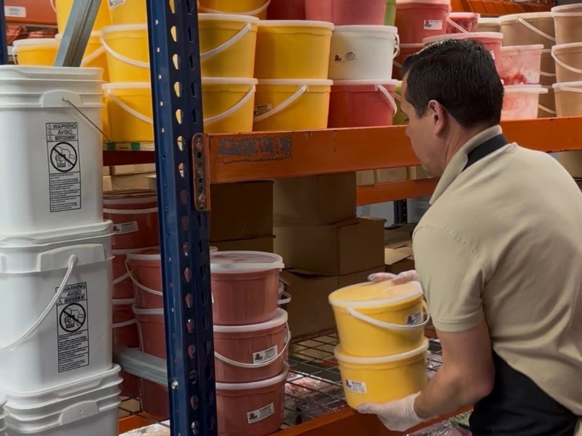 Helados Aranda team stocking buckets of ice cream at the distribution center